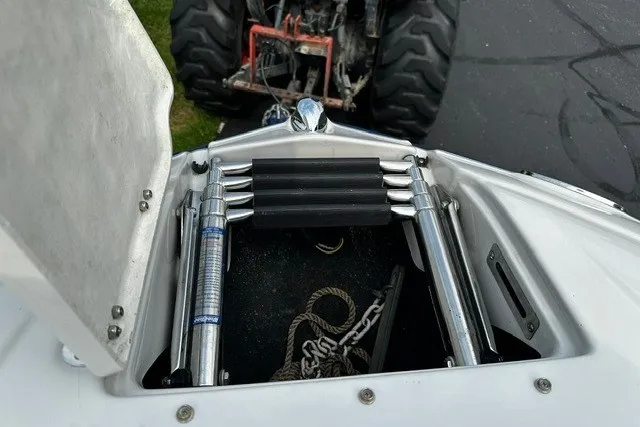 Slide: The Image of Open hatch of 2007 Crownline 260 LS boat showing anchor storage and ladder. - 23