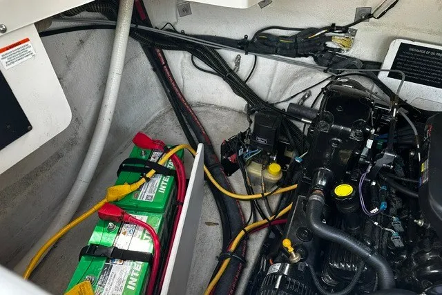 Slide: The Image of Engine compartment of a 2007 Crownline 260 LS boat with batteries and wiring. - 29