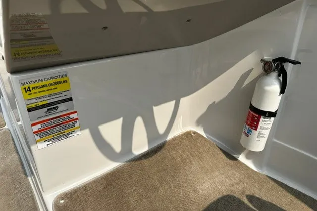 Slide: The Image of 2007 Crownline 260 LS boat interior with fire extinguisher and capacity label. - 14