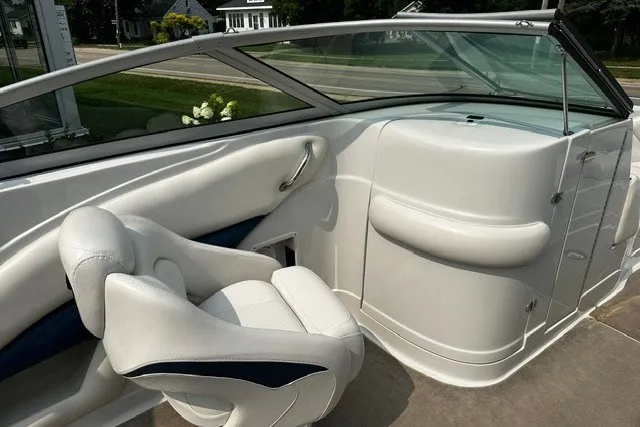 Slide: The Image of 2007 Crownline 260 LS boat interior with white seating and sleek dashboard design. - 15