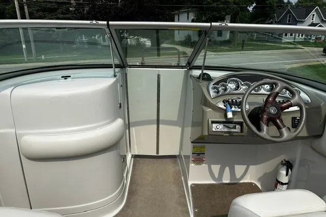 Slide: The Image of 2007 Crownline 260 LS boat interior with steering wheel and dashboard controls. - 19