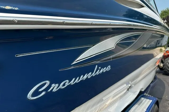 Slide: The Image of 2007 Crownline 260 LS boat, blue exterior with sleek design and logo detail. - 6