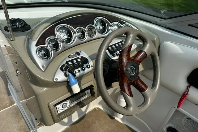 Slide: The Image of 2007 Crownline 260 LS boat dashboard with steering wheel and instrument panel. - 12