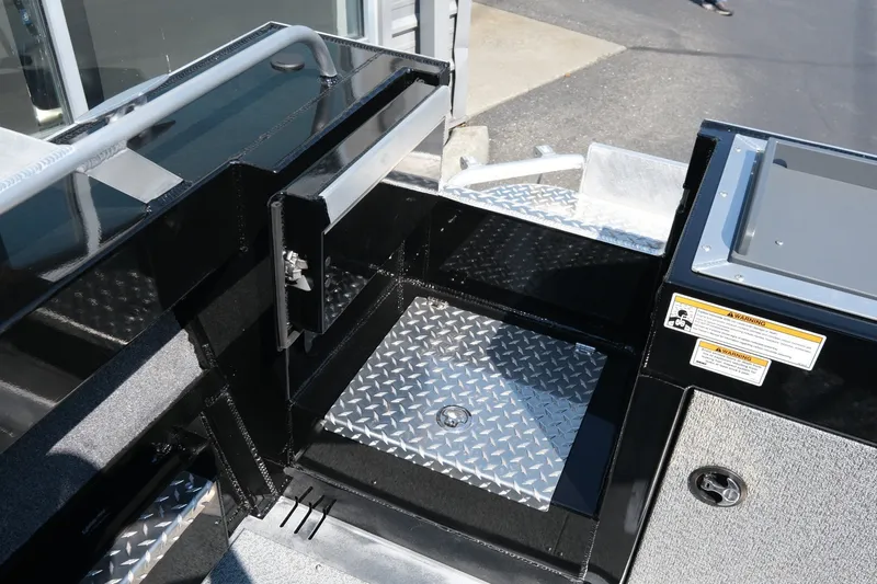 Slide: The Image of 2026 Hewescraft 190 Sea Runner ET boat interior with diamond plate flooring and storage compartments. - 16