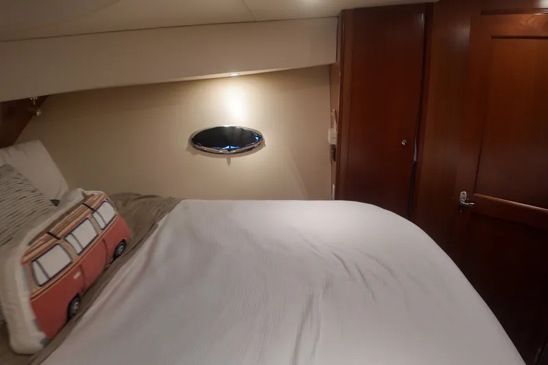 Slide: The Image of Interior cabin of 2007 Silverton 38 Convertible yacht with cozy bedding and decorative pillow. - 21