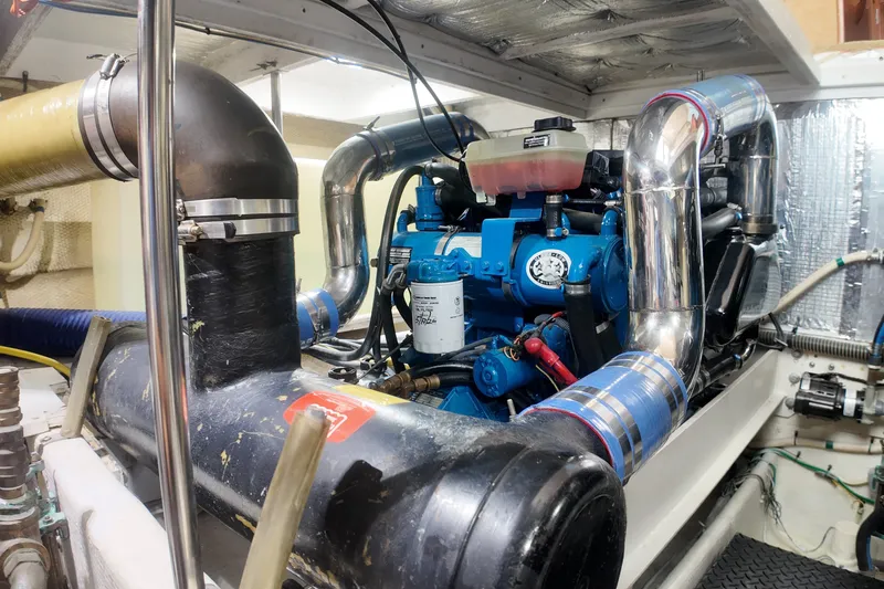 Slide: The Image of Engine room of a 2007 Silverton 38 Convertible yacht, showcasing complex machinery. - 29