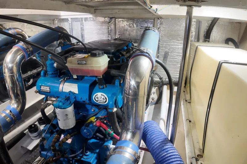 Slide: The Image of Engine room of 2007 Silverton 38 Convertible with blue marine engine components. - 30