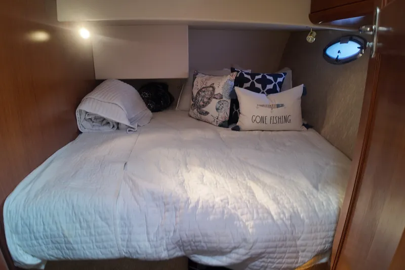 Slide: The Image of Cozy cabin bedroom in 2007 Silverton 38 Convertible yacht with nautical-themed pillows. - 25