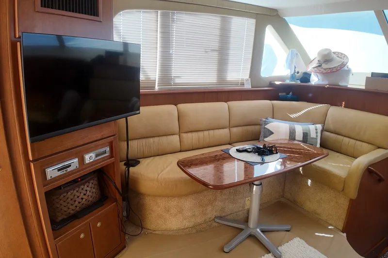 Slide: The Image of Interior of 2007 Silverton 38 Convertible yacht with cozy seating and TV. - 17