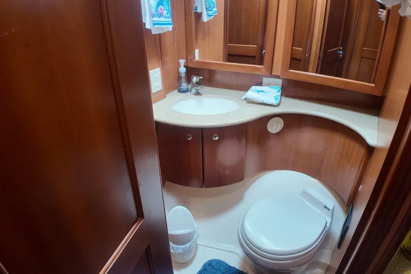 Slide: The Image of Luxurious bathroom in 2007 Silverton 38 Convertible yacht with wooden cabinetry and modern fixtures. - 23