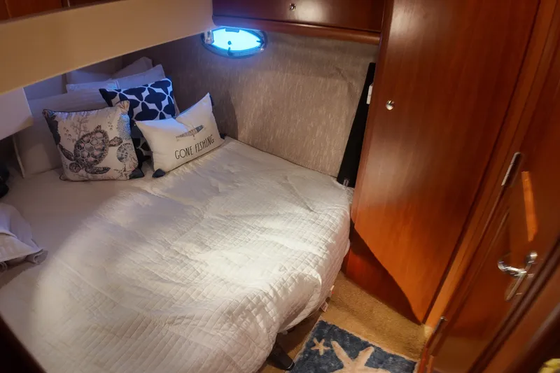 Slide: The Image of Cozy cabin interior of 2007 Silverton 38 Convertible yacht with nautical-themed pillows. - 26
