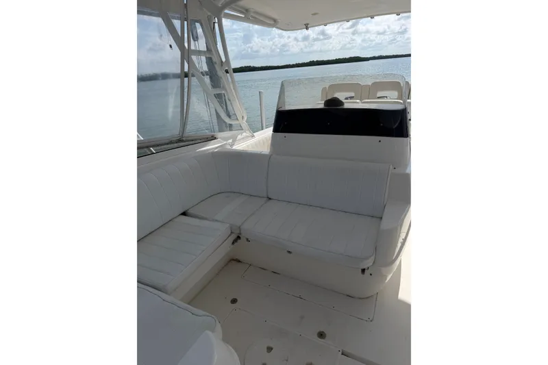 Slide: The Image of 2010 Intrepid 370 Cuddy interior with white seating, overlooking calm waters. - 15