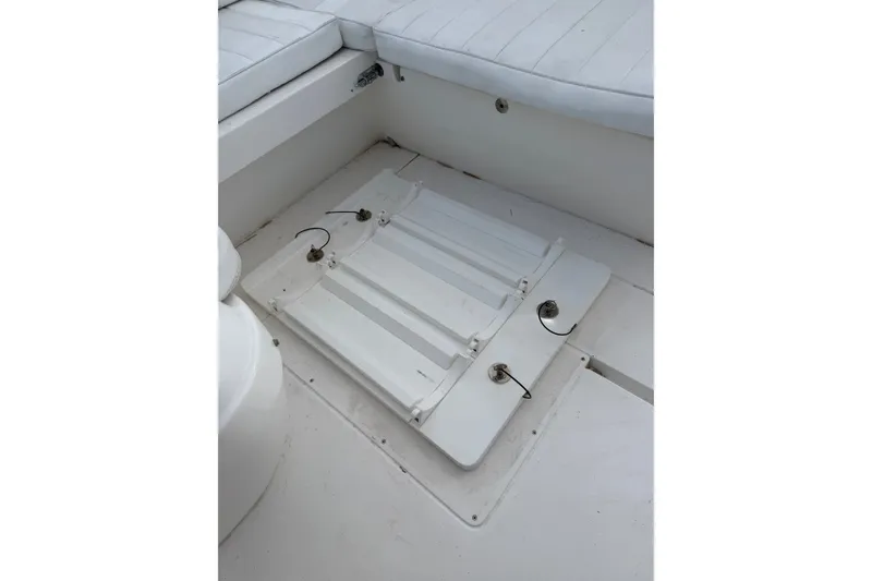 Slide: The Image of 2010 Intrepid 370 Cuddy boat interior with white seating and deck hatch. - 18