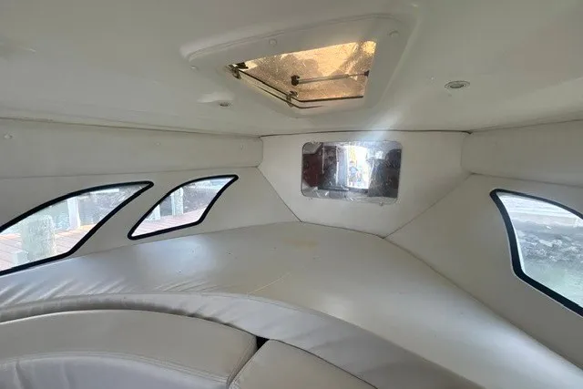 Slide: The Image of Interior cabin of 2010 Intrepid 370 Cuddy with cushioned seating and windows. - 12