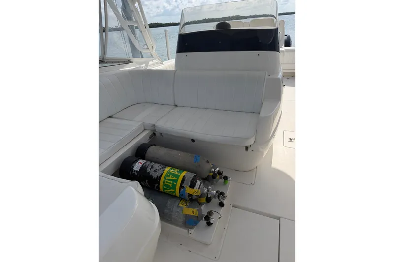 Slide: The Image of 2010 Intrepid 370 Cuddy boat interior with scuba tanks stored under seating. - 14