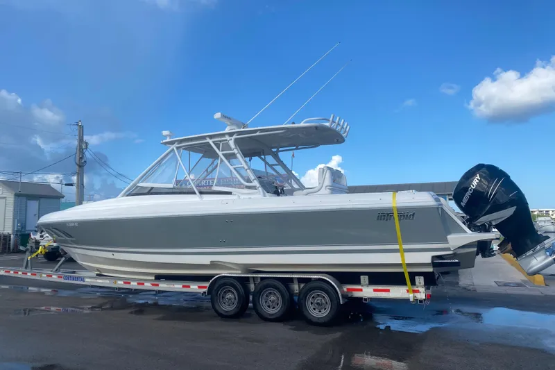 Slide: The Image of 2010 Intrepid 370 Cuddy boat on trailer under clear blue sky. - 1