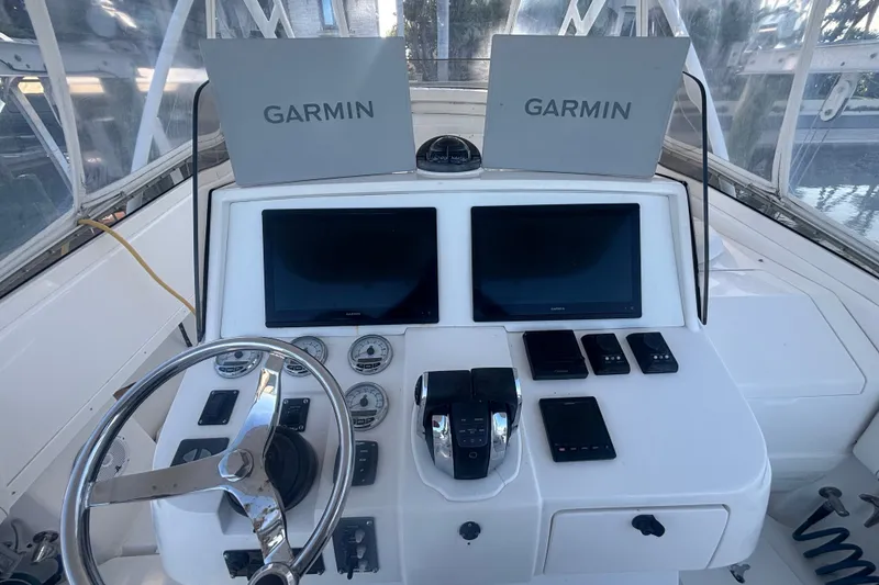 Slide: The Image of Helm of 2010 Intrepid 370 Cuddy with Garmin navigation displays and controls. - 13