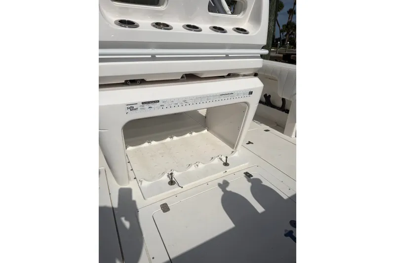Slide: The Image of 2010 Intrepid 370 Cuddy boat interior with storage compartment and rod holders. - 17