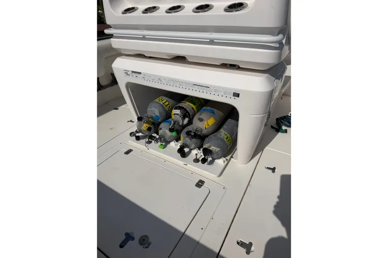 Slide: The Image of 2010 Intrepid 370 Cuddy boat with scuba tanks stored in compartment. - 16
