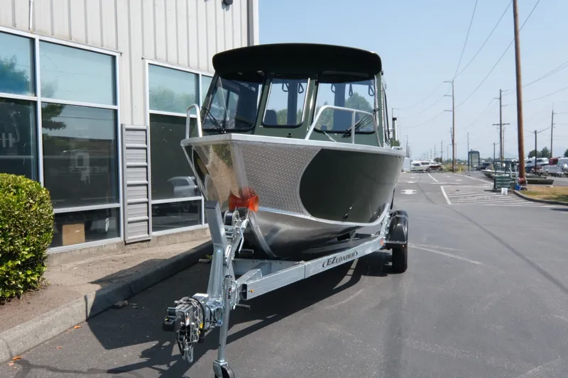 Slide: The Image of 2022 Hewescraft 190 Sea Runner ET Hardtop boat on trailer outside building. - 3
