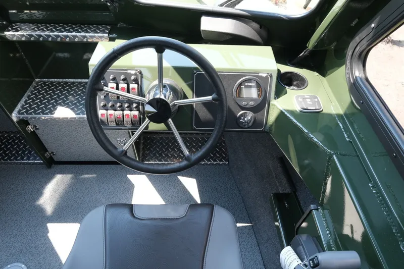 Slide: The Image of Interior of 2022 Hewescraft 190 Sea Runner ET Hardtop boat, featuring steering wheel and controls. - 13