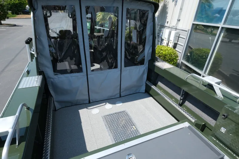 Slide: The Image of 2022 Hewescraft 190 Sea Runner ET Hardtop boat interior with gray flooring and covered seating area. - 6