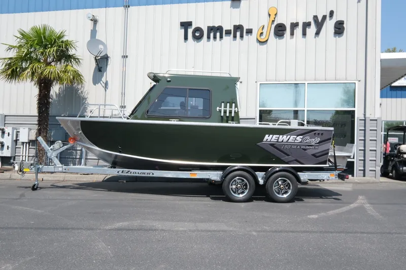 Slide: The Image of 2022 Hewescraft 190 Sea Runner ET Hardtop boat on trailer outside dealership. - 2