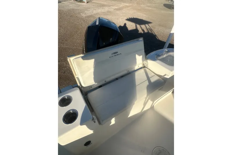 Slide: The Image of 2021 Cobia 220 Center Console boat interior with seating and cup holders. - 11