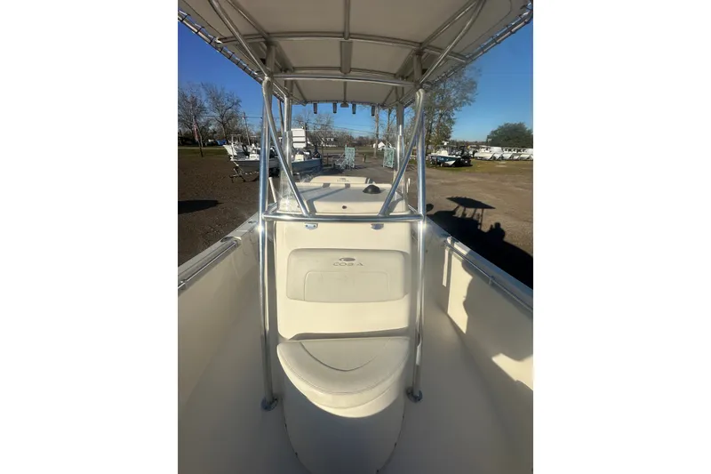 Slide: The Image of 2021 Cobia 220 Center Console boat interior with T-top and seating. - 14