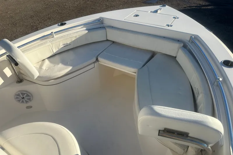 Slide: The Image of 2021 Cobia 220 Center Console boat with white cushioned seating and stainless steel railings. - 16