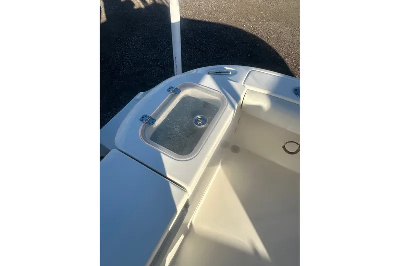 Slide: The Image of 2021 Cobia 220 Center Console boat interior with storage compartment and clean design. - 12