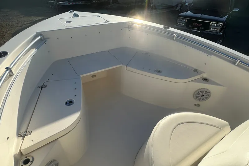 Slide: The Image of 2021 Cobia 220 Center Console boat interior with seating and storage compartments. - 13