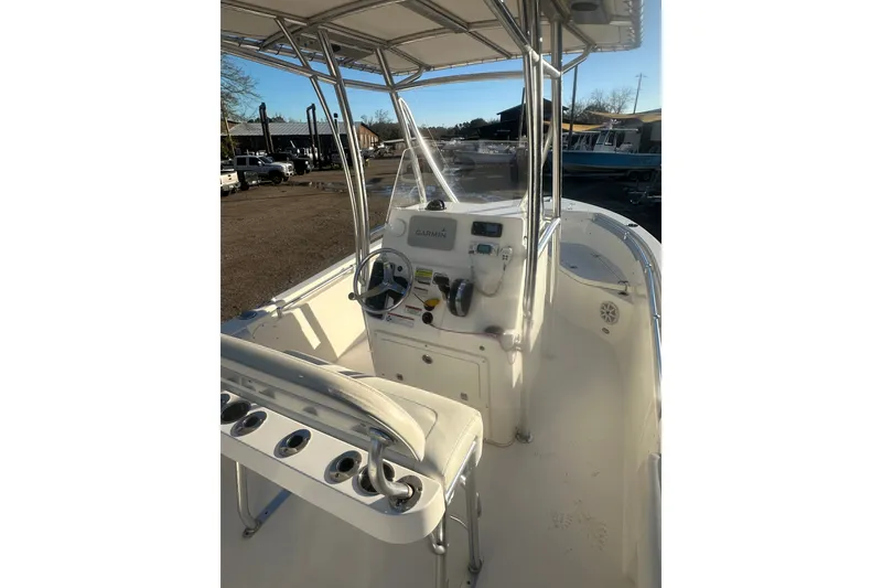 Slide: The Image of 2021 Cobia 220 Center Console boat interior with steering wheel and navigation equipment. - 8