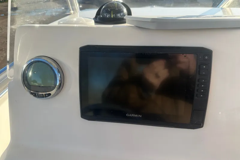 Slide: The Image of Cobia 220 Center Console 2021 dashboard with Garmin display and compass. - 20