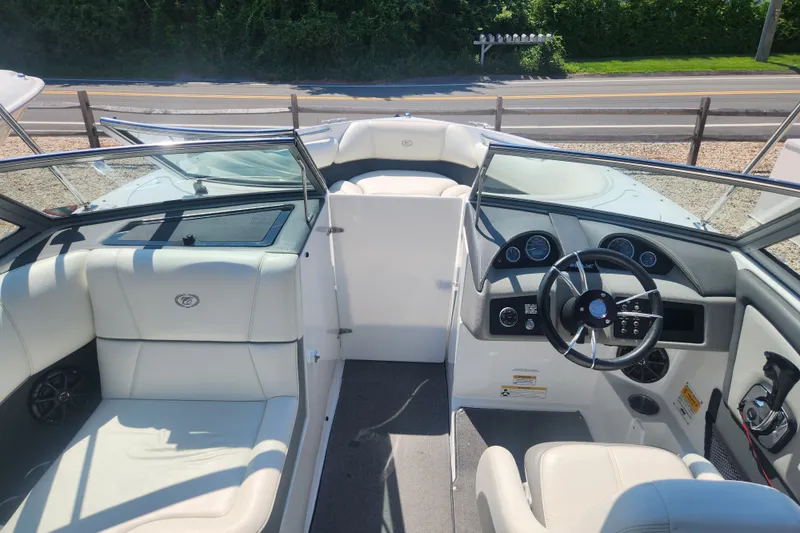 Slide: The Image of Interior view of a 2012 Cobalt 220 boat with white seating and dashboard. - 5