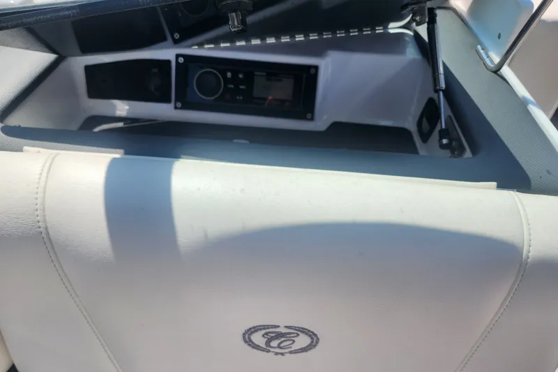 Slide: The Image of Interior of a 2012 Cobalt 220 boat, featuring a dashboard and white seating. - 6