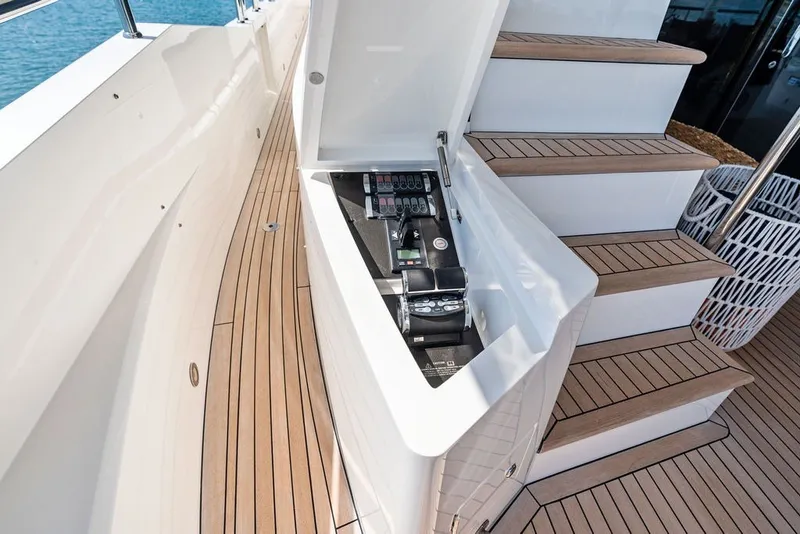 Slide: The Image of Control panel on 2019 Sunseeker 86 Yacht, featuring sleek wooden deck and modern design. - 58