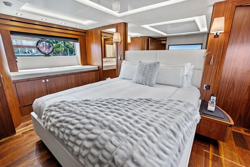 Slide: The Image of Luxurious bedroom interior of 2019 Sunseeker 86 Yacht with elegant wood paneling. - 76