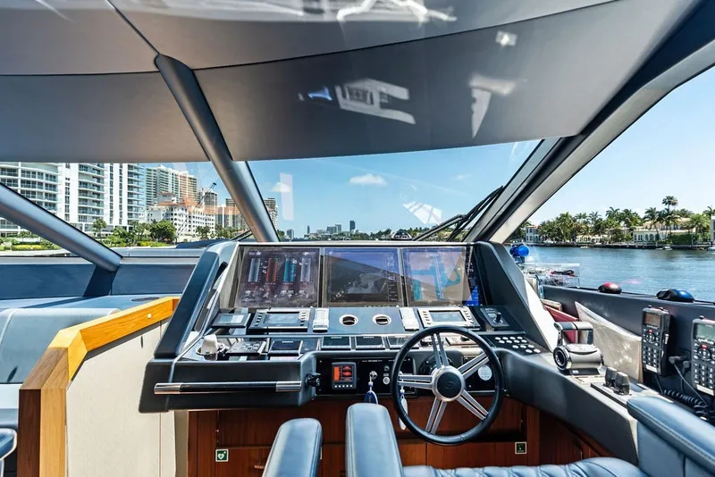 Slide: The Image of Cockpit view of 2019 Sunseeker 86 Yacht, featuring modern navigation equipment and waterfront cityscape. - 114