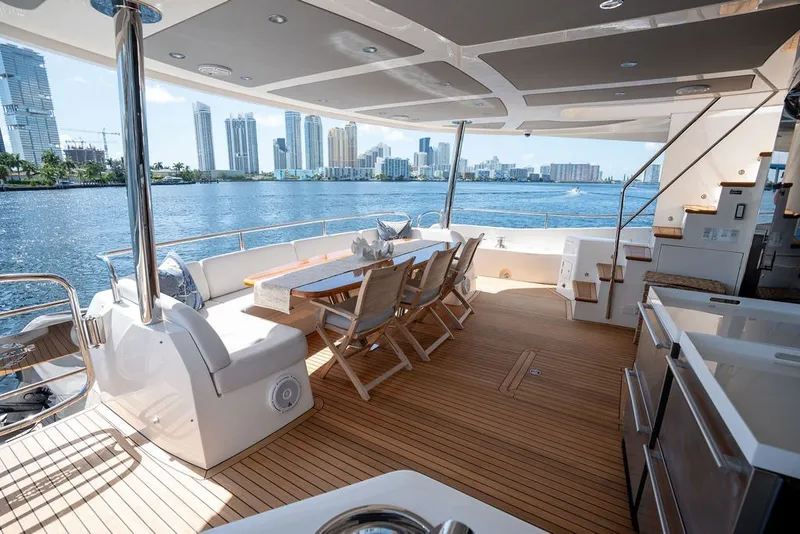 Slide: The Image of Luxurious 2019 Sunseeker 86 Yacht deck with elegant seating and stunning waterfront city view. - 38