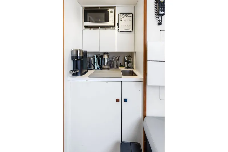 Slide: The Image of Compact kitchenette on 2019 Sunseeker 86 Yacht with modern appliances and storage. - 135