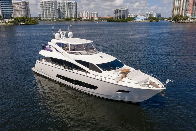 Slide: The Image of Luxurious 2019 Sunseeker 86 Yacht cruising in a scenic waterfront setting. - 7