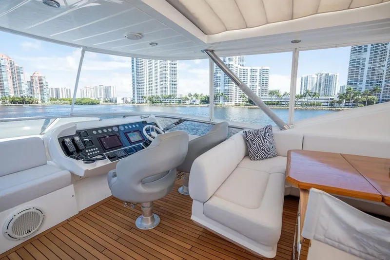 Slide: The Image of Luxurious 2019 Sunseeker 86 Yacht interior with modern helm, plush seating, and scenic waterfront views. - 51