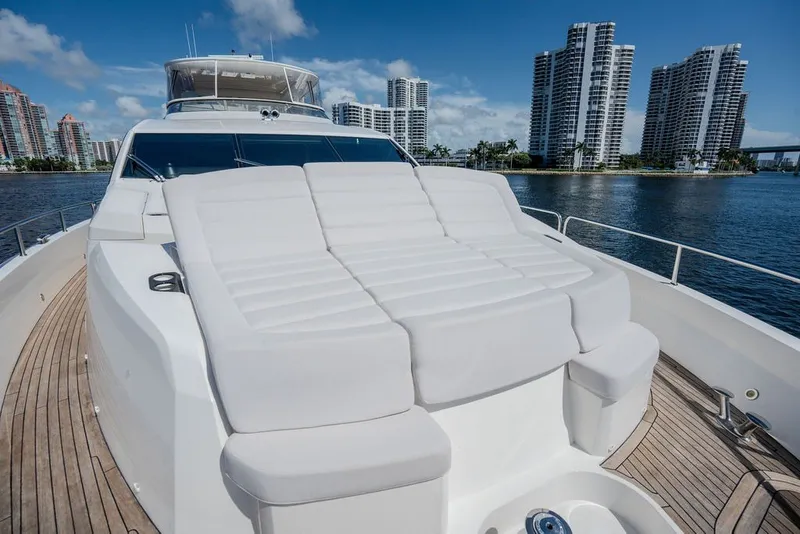 Slide: The Image of Luxurious 2019 Sunseeker 86 Yacht with spacious sunbathing area, city skyline in background. - 27