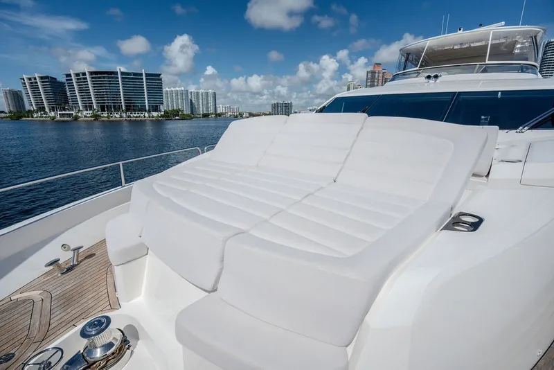 Slide: The Image of Luxurious 2019 Sunseeker 86 Yacht with spacious sunbathing area, city skyline in background. - 28