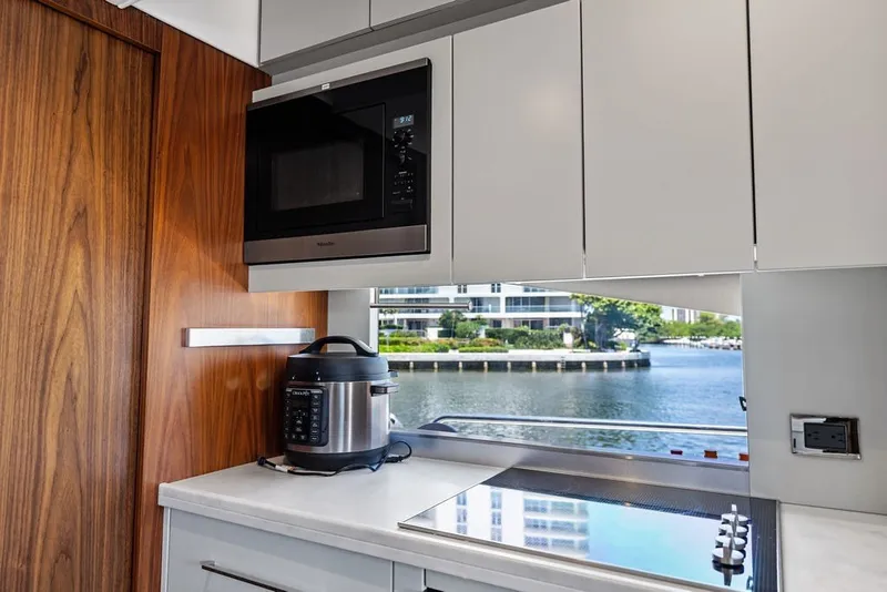 Slide: The Image of Modern kitchen interior on 2019 Sunseeker 86 Yacht with appliances and waterfront view. - 127