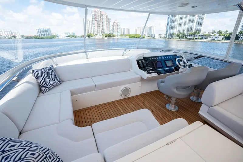 Slide: The Image of Luxurious 2019 Sunseeker 86 Yacht helm with plush seating and scenic waterfront views. - 52