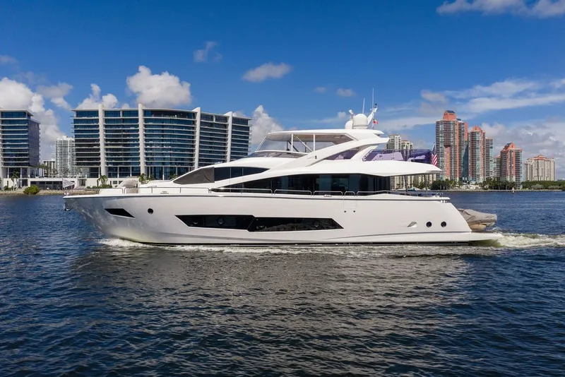 Slide: The Image of 2019 Sunseeker 86 Yacht cruising near modern city skyline on a sunny day. - 16