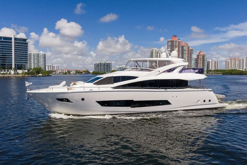 Slide: The Image of 2019 Sunseeker 86 Yacht cruising near modern city skyline on a sunny day. - 1