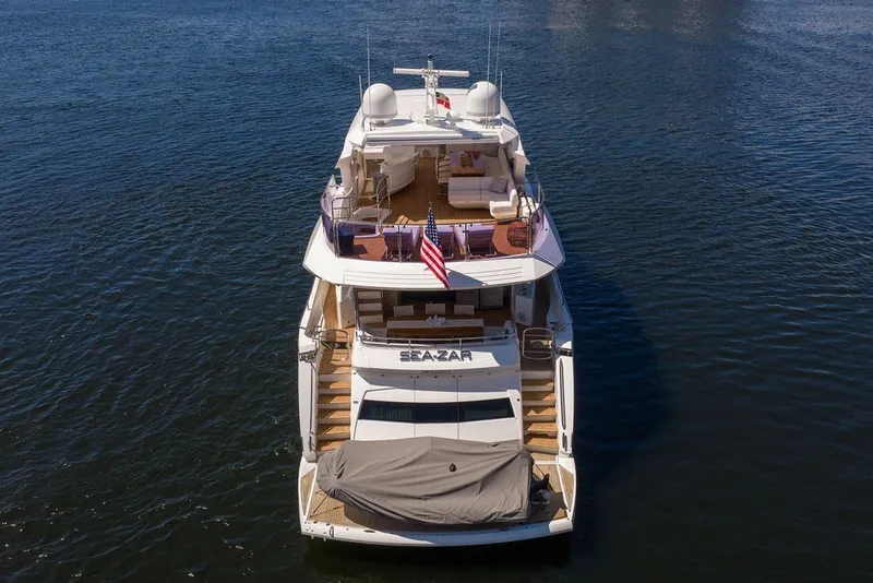 Slide: The Image of 2019 Sunseeker 86 Yacht on water, rear view with American flag. - 4